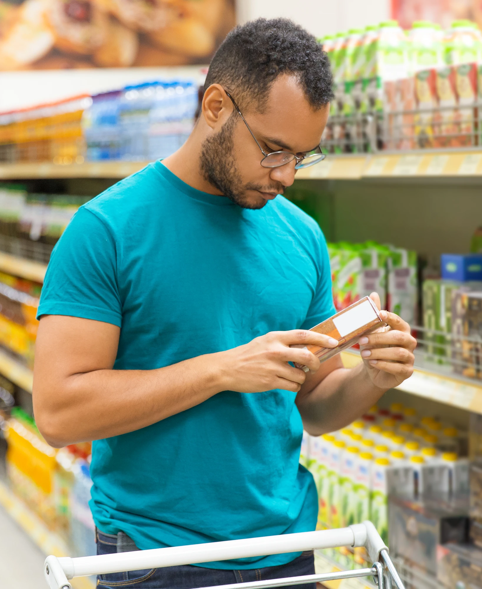 Person checking nutrition label in shop